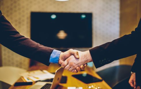 A close up of two people shaking hands to represent a mutually beneficial sponsorship.