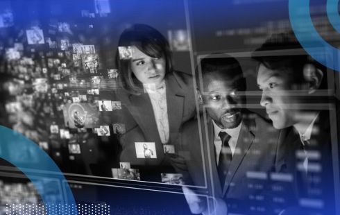 Three people in conversation while looking at holographic data.