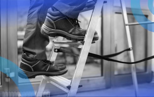 A closeup of a worker in boots climbing a ladder