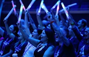 Attendees at Anthology Together 2025 waving glowsticks